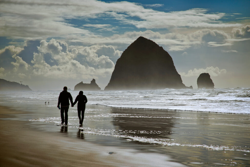 Couple walking on Cannon Beach, Oregon