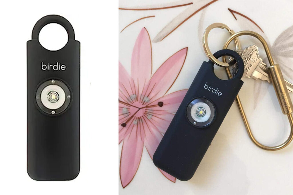 Two close ups of the Birdie Personal Safety Alarm, one on a white backdrop (left) and one on a pink floral backdrop, showing the alarm on a gold carabiner (right)