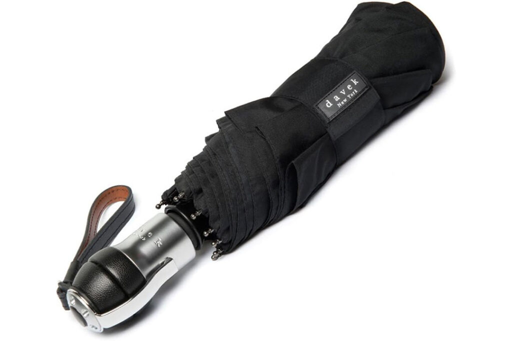 Davek Solo Umbrella in black, collapsed and held together with a velcro strap, best travel umbrella
