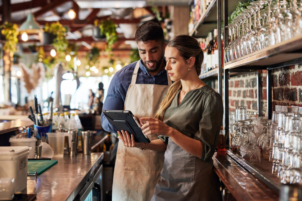 Managers checking their restaurant tech.